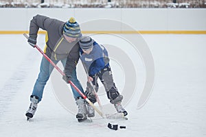 Father with his son playing hockey