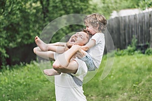 Father and his son playing and hugging in outdoors. Concept of Father`s day.