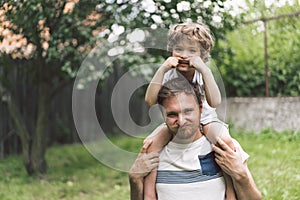 Father and his son playing and hugging in outdoors. Concept of Father`s day.