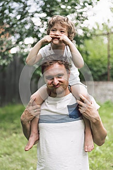 Father and his son playing and hugging in outdoors. Concept of Father`s day.