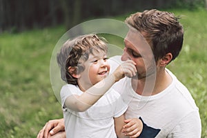 Father and his son playing and hugging in outdoors. Concept of Father`s day.