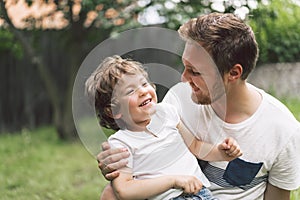 Father and his son playing and hugging in outdoors. Concept of Father`s day.