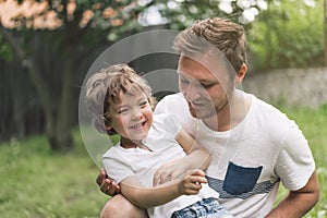 Father and his son playing and hugging in outdoors. Concept of Father`s day.