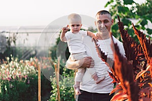 Father and his son playing and hugging in outdoors. Concept of Father`s day