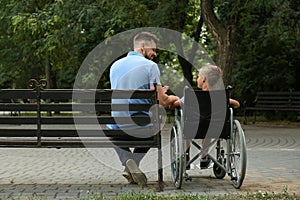 Father with his son in wheelchair at