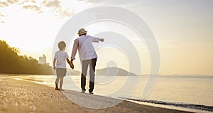 Father and his son who enjoy a picnic and sea bathing at the beach on sunset in holiday