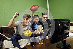 Father and his sons celebrating touchdown