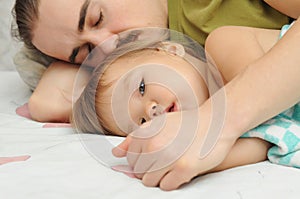 Father holding ailing baby hands