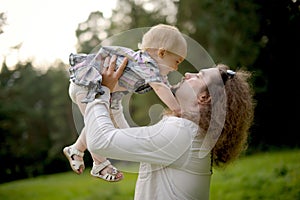 Father holding baby girl and going to kiss her