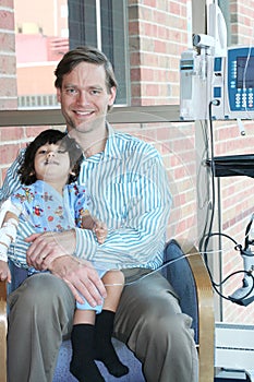 Father holding child in hospital