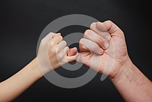 Father holding Daughter hand. Friendly parental relationships. Black Background.