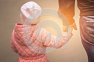 Father holding daughter`s hand.  Father`s day concept