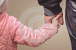 Father holding daughter`s hand.  Father`s day concept