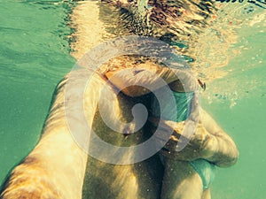 Father holding daughter underwater