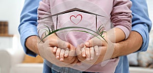 Father holding hands with child and illustration of house indoors. Adoption concept