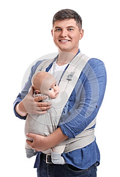 Father holding his child in baby carrier on white background