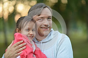 father holding his daughter in his arms