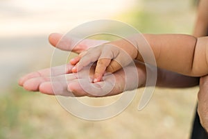 Father holding his daughter`s hand