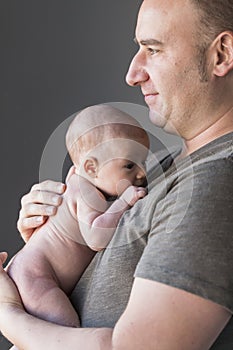 Father holding his newborn baby girl. love and family concept