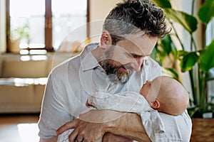 Father holding his newborn baby. Unconditional paternal love, Father's Day concept.