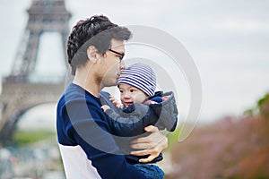 Father holding his son near the Eiffel tower