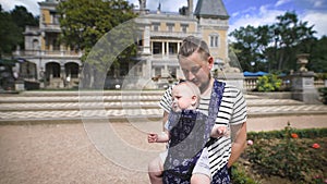 Father holding his young son. They travel together