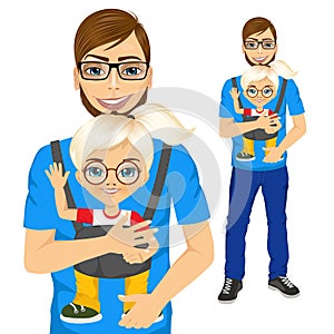 Father holding little girl with baby carrier