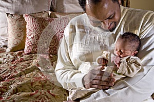 Father holding newborn baby