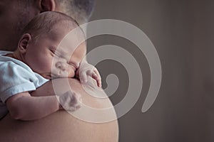 Father holding newborn baby son at the day time