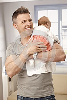 Father holding tiny baby
