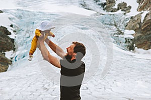 Father holding up baby hiking together