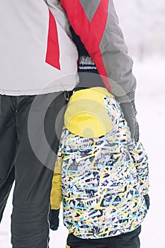 Father holds the boy`s hand in winter clothes, winter, family, hand in hand, lifestyle