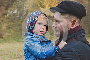 Father holds daughter on hand while she is crying