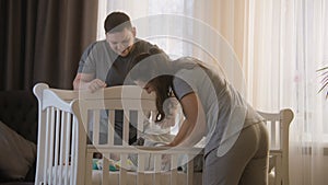 Father holds daughter in his arms and gives baby to wife