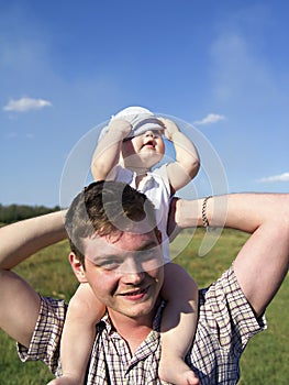 Father holds a small child on his shoulders
