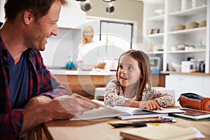 Father home schooling his young daughter photo