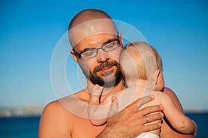 Father hugging his newborn baby