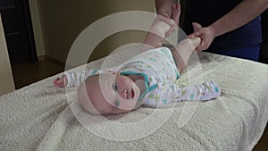 Father with infant baby do exercises for tonicity treatment. 4K