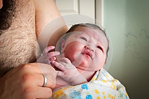 Father Inspects Newborn Baby Fingers