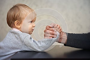 Father and kid arm wrestling competition
