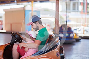 Father and kid having fun, theme park.