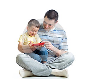 Father and kid are looking to play and read tablet computer