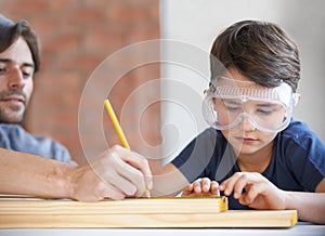 Father, kid and woodwork at home for project, bonding and building with safety gear. Dad, son and carpenter for