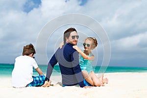 Father with kids at beach