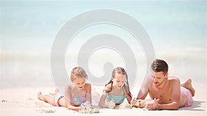 Father and kids enjoying beach summer tropical vacation