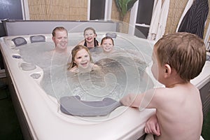 A father and kids in hot tub photo