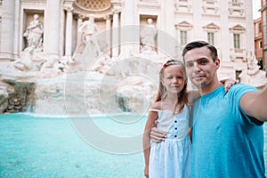 Father and kids near Fontana di Trevi, Rome, Italy.