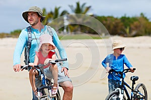 Father and kids riding bikes