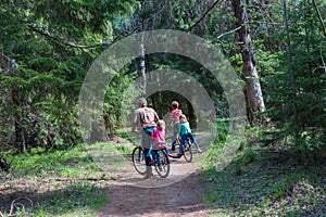 Father with kids riding bikes in nature