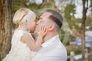 Father Kisses His Cute Baby Girl Outside at the Park